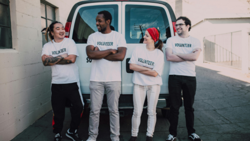 a group of volunteers standing by a van