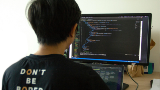 man looking at code on monitor