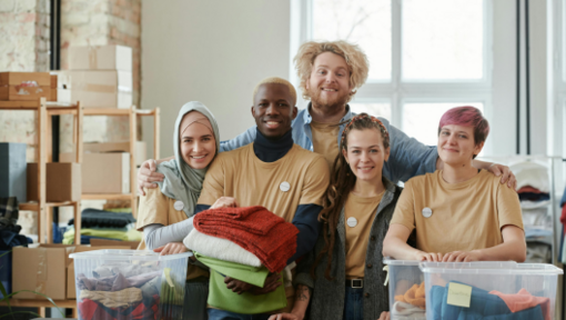 a group of volunteers posing with donations